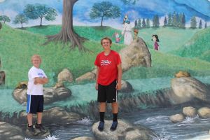 Our kids with one of the beautiful murals painted by a local artist